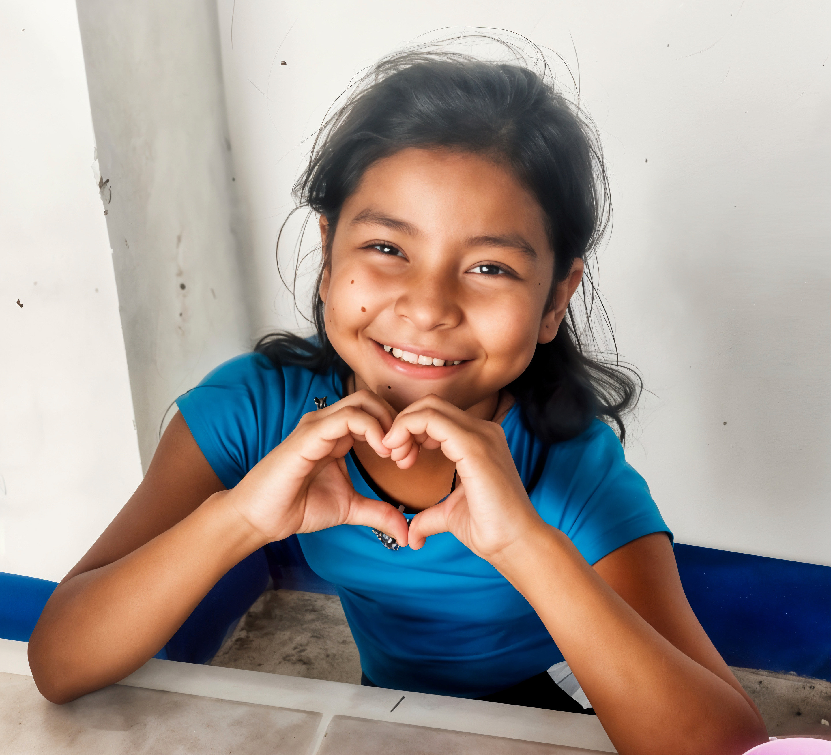 Girl making a heart with her hands